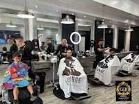 a barber shop with a child sitting in front of a mirror