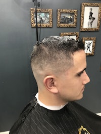 a man with a shaved head in a barber shop