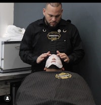 a man is getting a haircut in a barber shop